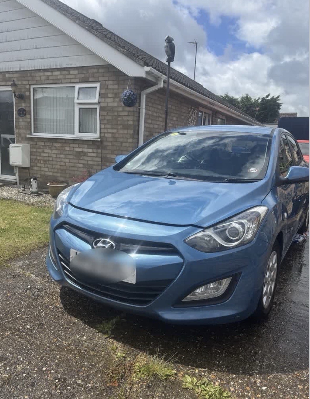 Blue Hyundai i30 washed and dried on the driveway